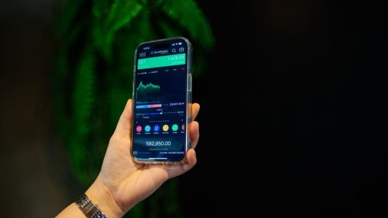 Layar smartphone menampilkan aplikasi keuangan, ilustrasi asuransi digital dan unit link